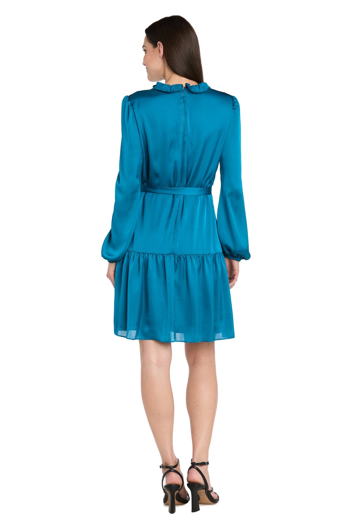A woman faces away, wearing the R&M Richards 4246 short teal party dress with long sleeves, a ruffled collar, and tiered skirt, styled with black heeled sandals for a chic semi-formal look.